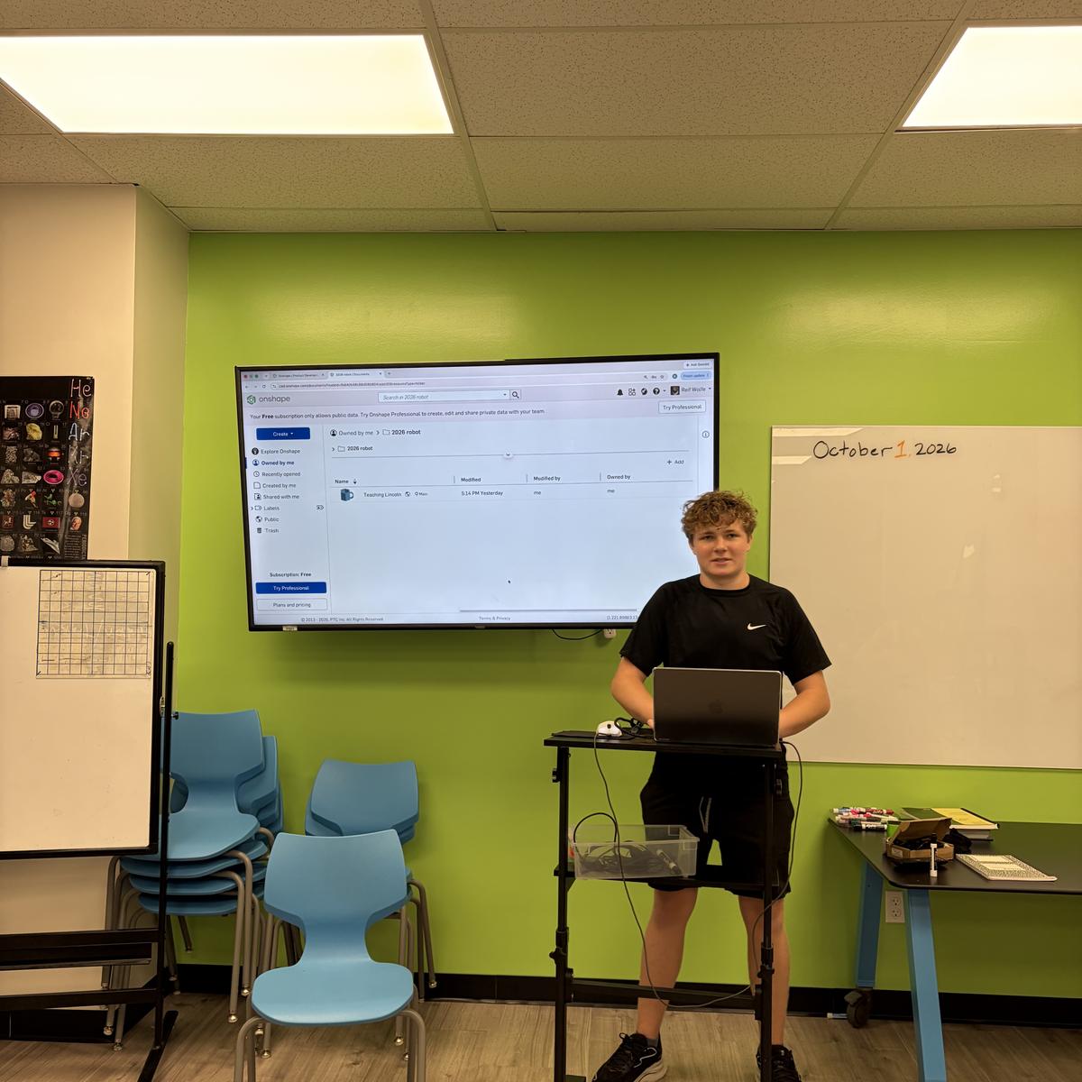 A team member presenting a design on a classroom screen