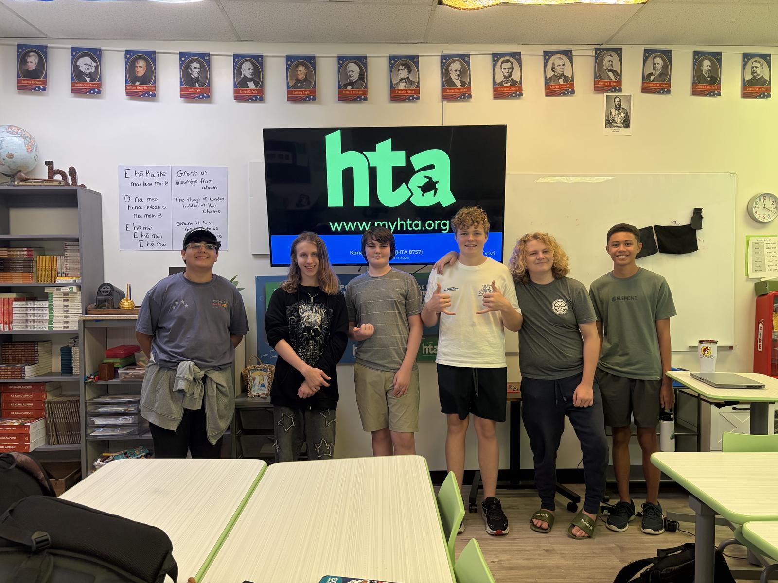 The Turtle Ctrl team standing together in an HTA classroom